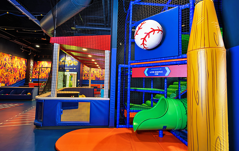 View of Slide exit with baseball and yellow crayon props